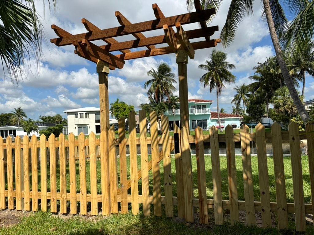 Completed pergola and picket fence with waterfront backdrop